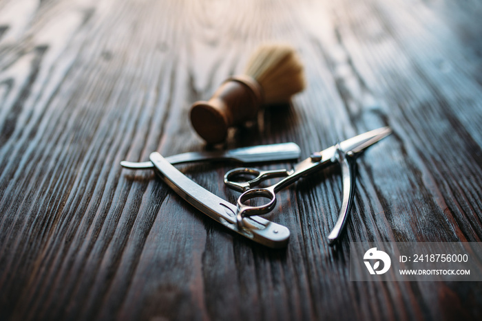 Shaving and barber equipment on wooden background