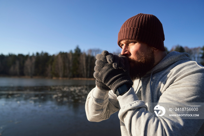 Adult caucasian man warming up before winter swimming