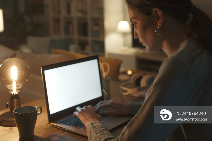 Woman working with her laptop at night