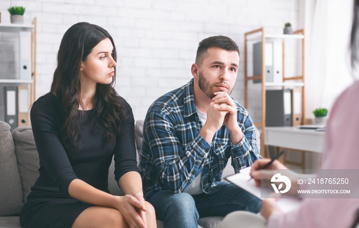 Serious man talking to psychiatrist during marital therapy session