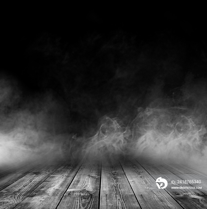 Wooden table with smoke and black backgrounds