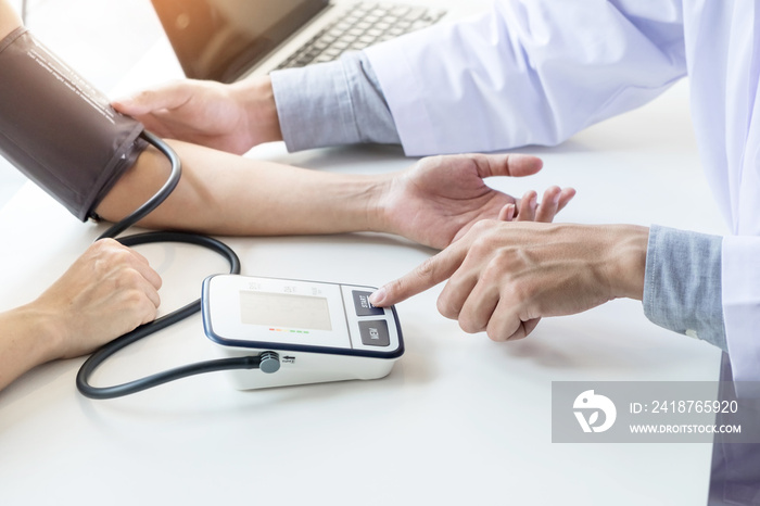 healthcare, hospital and medicine concept - doctor and patient measuring blood pressure