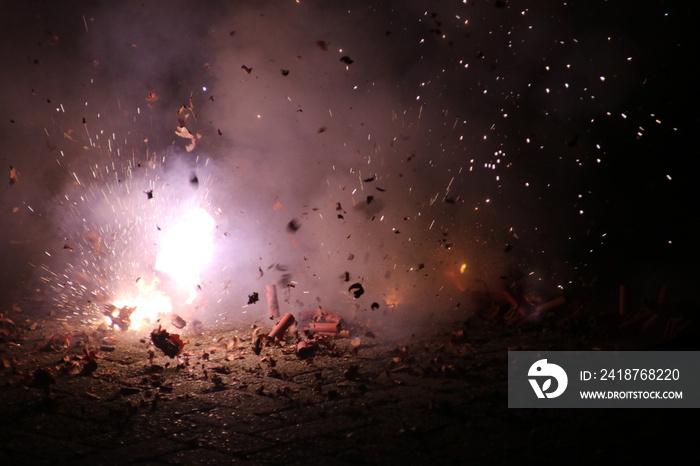 loud chinese crackers in a row are exploding during New Years Eve in the Netherlands where this kind