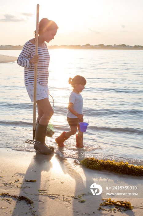 Mother and daughter (2-3) on beach