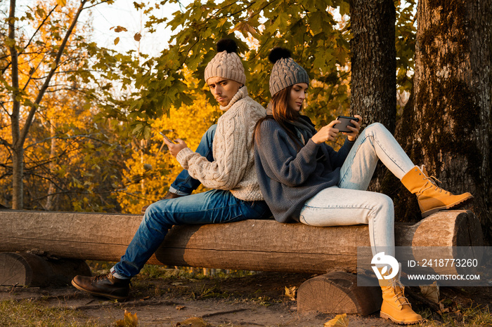 Young and happy couple in the autumn park