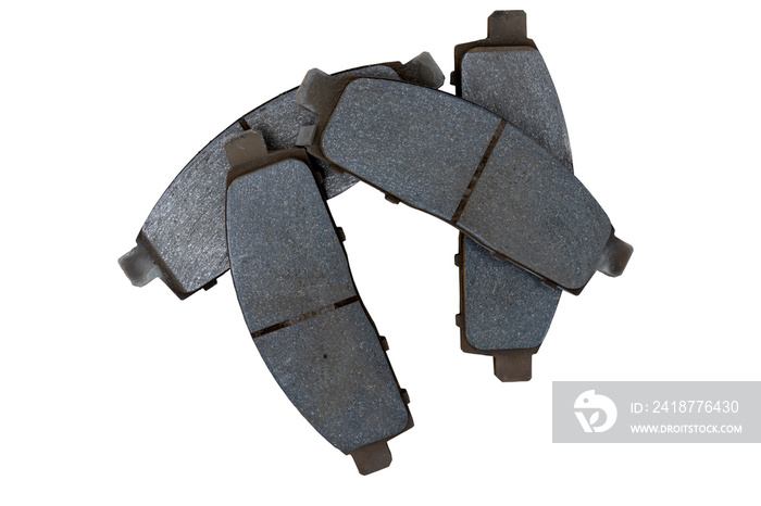 Four used car brake pads that are stacked together on isolated white background. with clipping path.