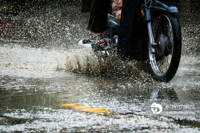 motion motorcycle  rain big dirty puddle of water spray from the wheels