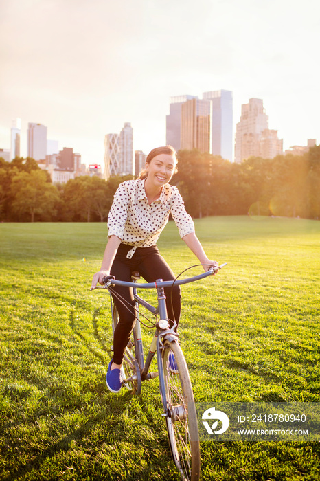 Young woman riding bicycle in Central Park