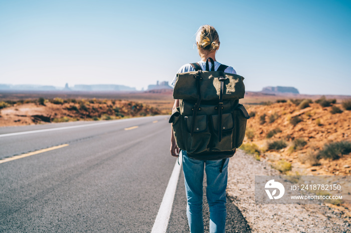 Female backpacker going towards Monument Valley