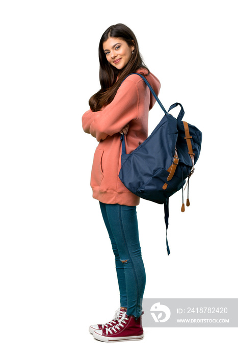 A full-length shot of a Teenager girl with sweatshirt and backpack keeping the arms crossed in later