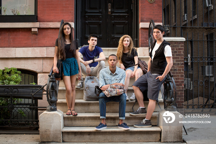 Portrait of friends on steps against building