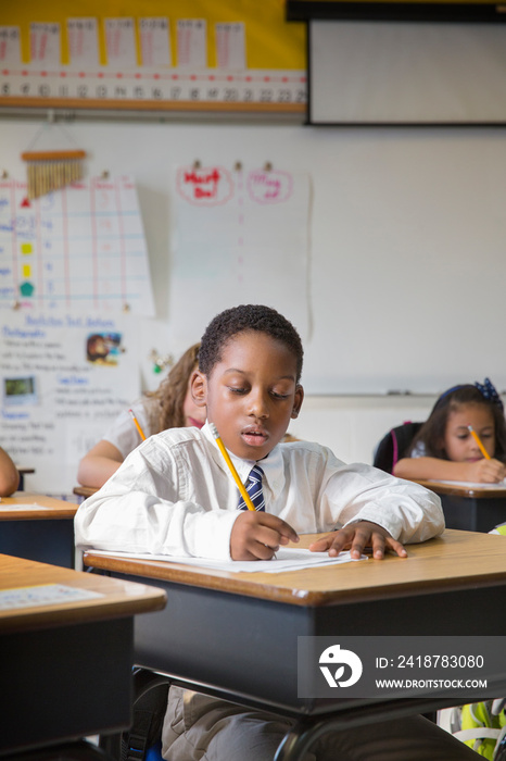 Students writing in classroom