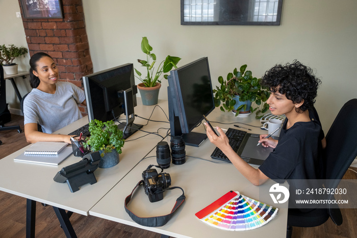 Young women working in creative office