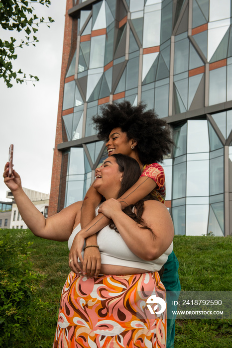 Two young women taking�selfie�in urban setting