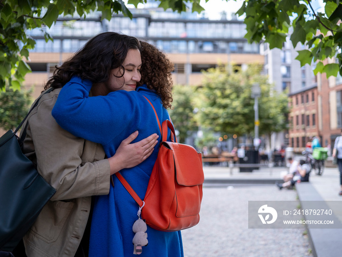 UK, Lesbian couple embracing outdoors