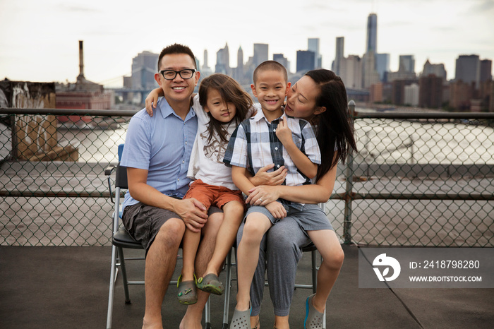 Smiling family sitting outdoors