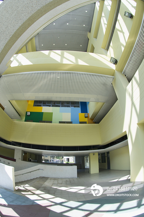 Hallway with yellow balcony; colorful wall and interlaced ceiling