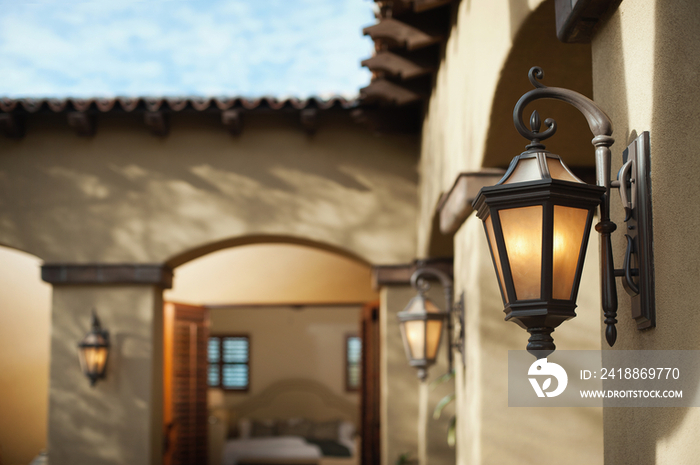 Lit lanterns with view of bedroom through open doors; Scottsdale; USA