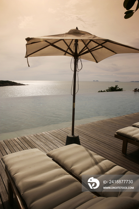 Thailand, Koh Samui Island, deckchairs and parasol at sunset