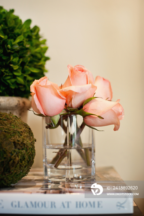 pink roses in glass at hotel