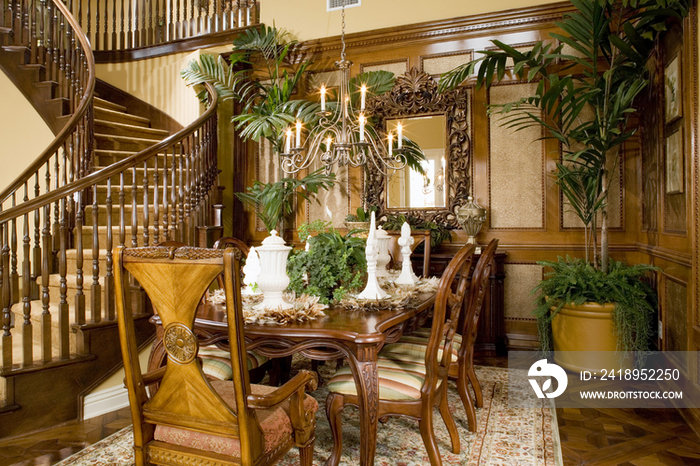 Dining table by staircase in traditional house; Oxnard; California; USA