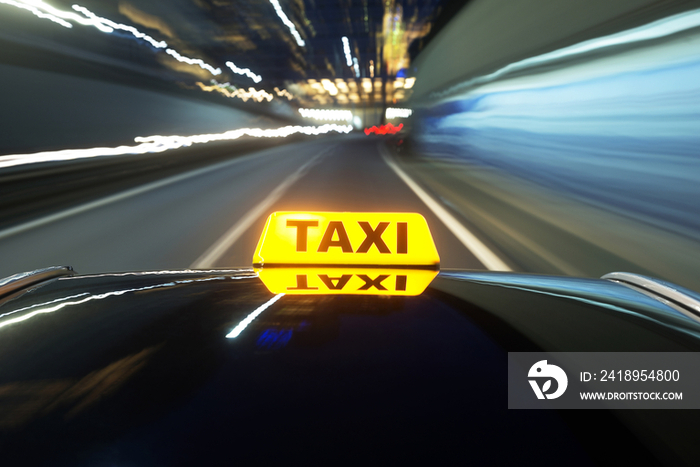 Taxi driving over a motorway at night