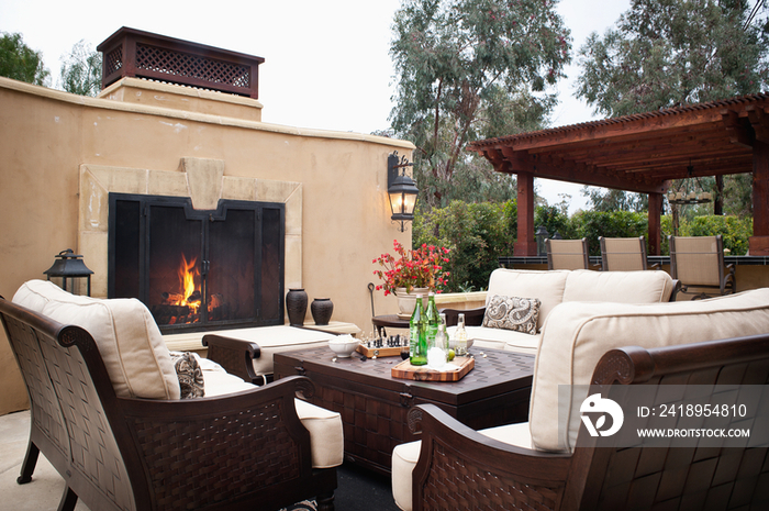 Outdoor furniture by fireplace at patio; Rancho Sante Fe; USA