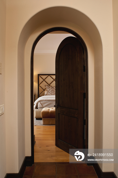 Half open door leading to contemporary bedroom at home