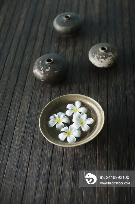 Petals of the orchid flower in a bowl of water