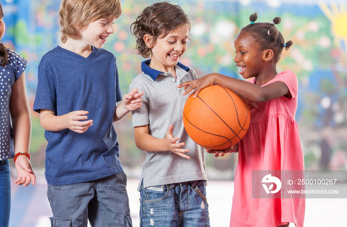 Mixed race classmates playing in schoolyard