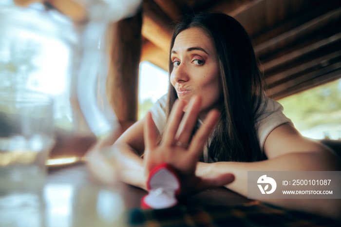 Unhappy Girlfriend Pushing Away Engagement Ring Refusing Proposal. Uninterested woman rejecting a gift from her ex-partner