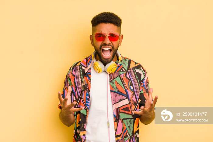 black afro man looking angry, annoyed and frustrated. sunglasses and headphones concept