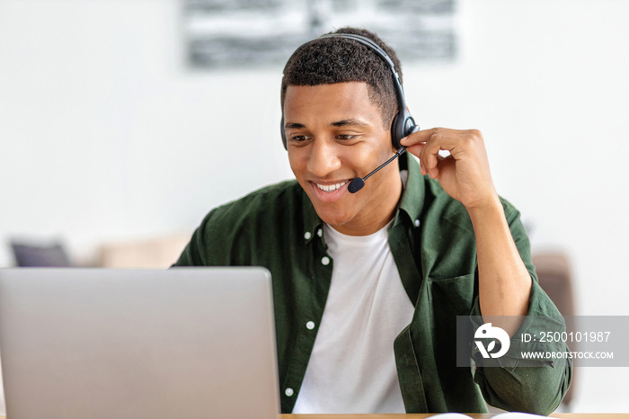 Portrait of happy African American male employee customer support services in headset, online consultation. Call center, customer support or sales man agen