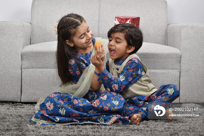 Indian asian cute little kids or siblings celebrating festival