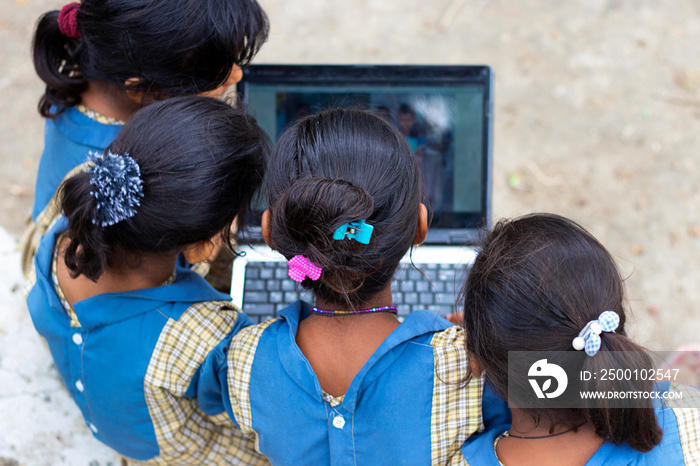 indian village government school girls operating laptop computer system at rural area in india