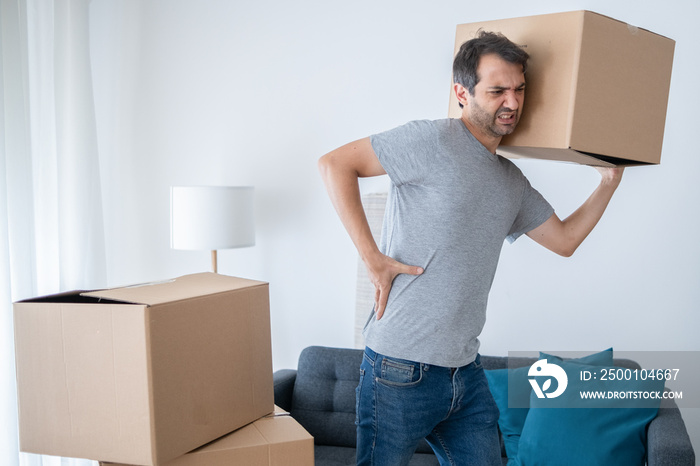 Man lifting boxes and moving into new house suffers backache