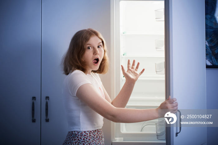 teen girl by the empty fridge