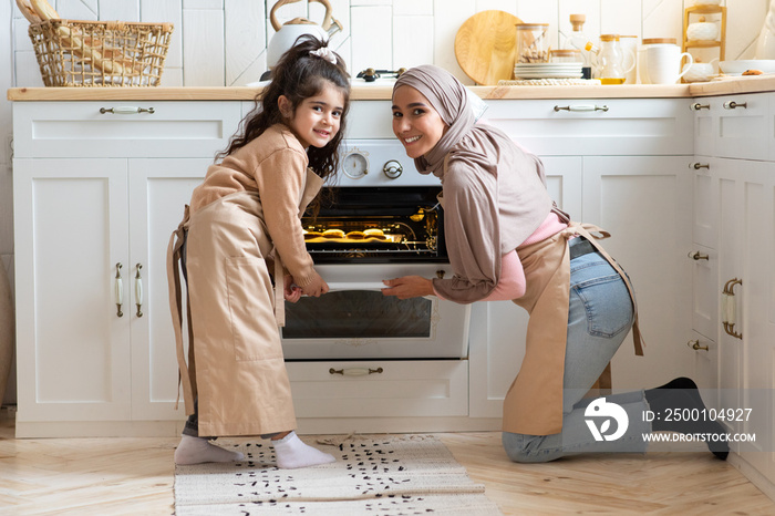 Portrait Of Happy Muslim Family Mother And Daughter Baking Together In Kitchen