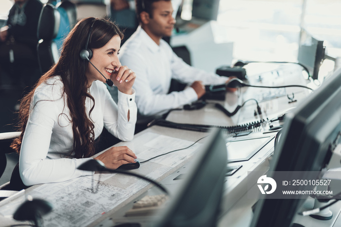 Cheerful female operator working on dispatch board