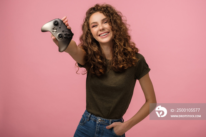 Pretty gamer girl on pink background