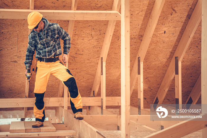 Construction Contractor Inside Newly Built Wooden House Skeleton