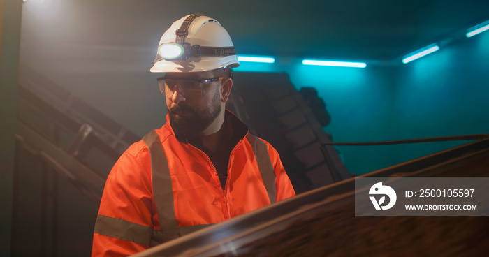 Male supervisor looking at conveyor belt