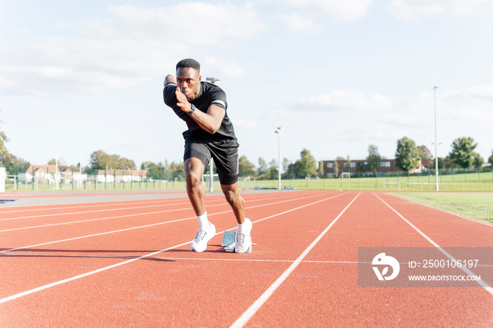 Athlete sprinting off at running track