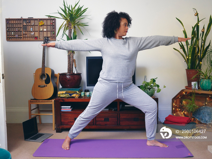 Woman practicing yoga at home