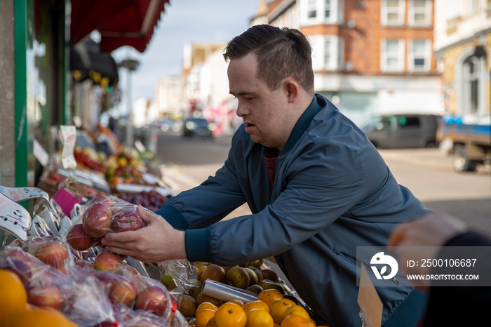 Man buying fruit in grocery store