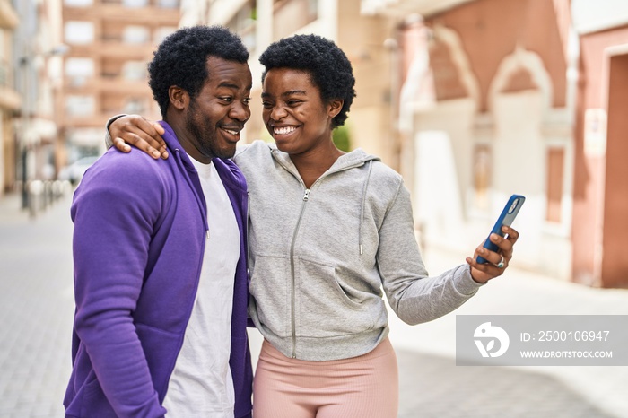 African american man and woman couple having video call at street