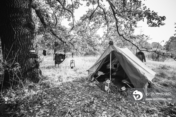 World War II German Wehrmacht Infantry Tent In Forest Camp. WWII WW2 German Ammunition. Photo In Black And White Colors