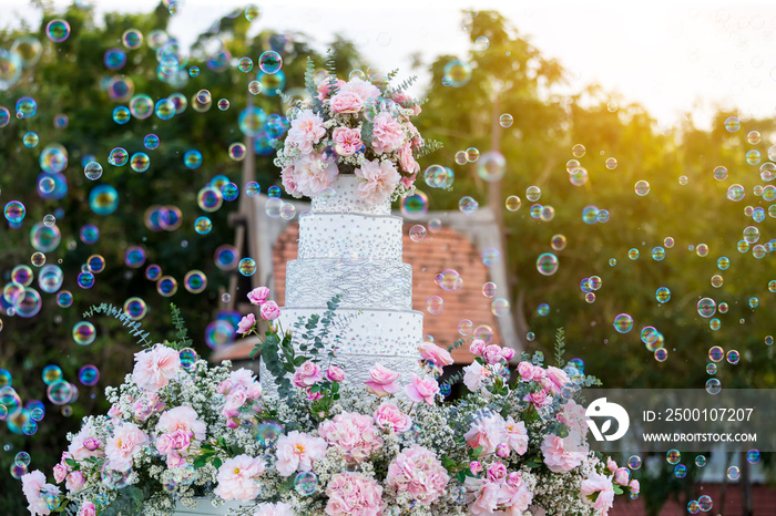 Decoration wedding with cake bubble and lighting in ceremony. Beautiful Wedding Cake. Abstract blurred soft of wedding cake and bubbles in the wedding banquet.