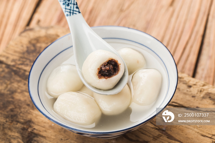 Tang Yuan(sweet dumplings) made from glutinous filled with black sesame in ginger syrup. Traditional cuisine for lantern festival, Mid-autumn festival, Dongzhi (winter solstice) and Chinese new year.