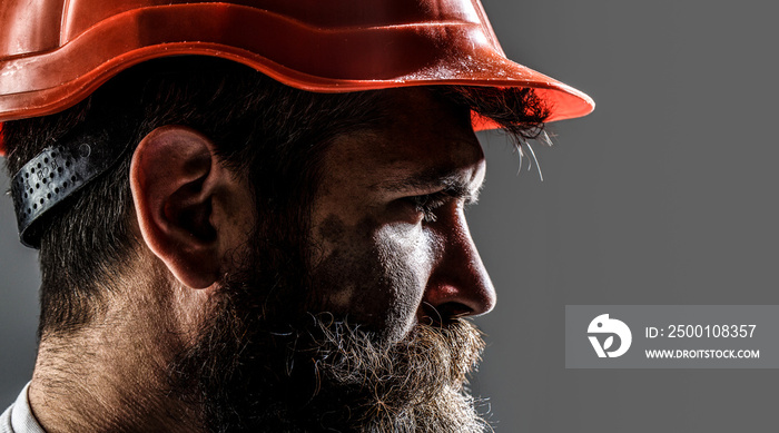 Portrait mechanical worker. Bearded man in suit with construction helmet. Portrait of handsome engineer. Builder in hard hat, foreman or repairman in the helmet. Construction worker in hardhat